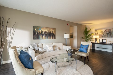 a living room with a couch and a glass table